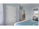Peaceful bedroom with calming blue walls, featuring a glimpse into the en-suite bathroom and its calming atmosphere at 2940 Moulin Rd, Davenport, FL 33837