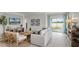Bright living room with neutral tones, offering a cozy atmosphere and scenic views of the outdoors at 2940 Moulin Rd, Davenport, FL 33837