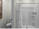 Bright bathroom featuring a toilet and shower with white shower curtain and shower at 2964 Moulin Rd, Davenport, FL 33837
