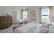 Bedroom showcasing a bed, a bench, wood flooring, and serene natural light at 2964 Moulin Rd, Davenport, FL 33837
