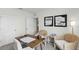 Light-filled office with desk, two woven chairs, and modern decor at 2964 Moulin Rd, Davenport, FL 33837