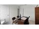 Another angle of the office space featuring a wooden desk, three chairs, and neutral walls at 2964 Moulin Rd, Davenport, FL 33837