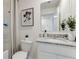 Bathroom featuring a granite countertop vanity, toilet, and shower with patterned shower curtain at 2995 Brie Hammock Bnd, St Cloud, FL 34773
