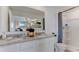 Bathroom featuring double sinks with granite countertop and white cabinets, with shower and toilet at 2995 Brie Hammock Bnd, St Cloud, FL 34773