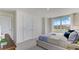 Inviting bedroom featuring a large window, plush carpet, and neutral color palette at 2995 Brie Hammock Bnd, St Cloud, FL 34773
