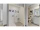 Laundry room with fun artwork and a bathroom with granite vanity, toilet, and shower in view at 2995 Brie Hammock Bnd, St Cloud, FL 34773