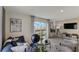 Comfortable living room with modern decor, a large window, and a relaxing view at 2995 Brie Hammock Bnd, St Cloud, FL 34773