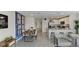 Open-concept living and dining area featuring modern decor, stainless steel appliances, and ample natural light at 2995 Brie Hammock Bnd, St Cloud, FL 34773