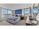Serene main bedroom suite with a large bed, blue accent wall, and abundant natural light at 2995 Brie Hammock Bnd, St Cloud, FL 34773
