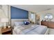 Cozy main bedroom with ensuite bathroom, blue accent wall, and ample closet space at 2995 Brie Hammock Bnd, St Cloud, FL 34773