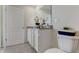 Bathroom featuring toilet and vanity with granite countertop and white cabinets. A door is visible to the left at 2999 Brie Hammock Bnd, St Cloud, FL 34773