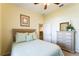 Bright bedroom featuring a queen bed, dresser with mirror, and neutral decor at 305 Grand Reserve Dr, Davenport, FL 33837