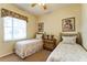 Cozy bedroom featuring twin beds, a window, and a floral decor at 305 Grand Reserve Dr, Davenport, FL 33837