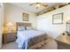 Comfortable bedroom with a queen-sized bed, closet, and neutral decor. Artwork on the walls at 305 Grand Reserve Dr, Davenport, FL 33837