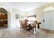 Inviting dining room featuring an arched doorway, tile flooring, and a wooden table with seating for six at 305 Grand Reserve Dr, Davenport, FL 33837
