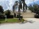 Charming one-story home with a three-car garage, manicured lawn, and mature landscaping at 305 Grand Reserve Dr, Davenport, FL 33837