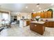 Open-concept kitchen with a center island, wood cabinets, and tile flooring at 305 Grand Reserve Dr, Davenport, FL 33837