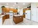 Spacious kitchen featuring a center island, wood cabinets, and modern appliances at 305 Grand Reserve Dr, Davenport, FL 33837