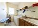 Functional laundry room featuring a washer, dryer, utility sink, and shelving at 305 Grand Reserve Dr, Davenport, FL 33837