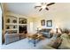Inviting living room with a ceiling fan, built-in display niches, and comfortable seating at 305 Grand Reserve Dr, Davenport, FL 33837