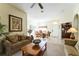 Bright living room with comfortable seating, decorative art, and an arched doorway to the dining area at 305 Grand Reserve Dr, Davenport, FL 33837