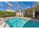 Beautiful screened-in pool and spa surrounded by lush landscaping at 305 Grand Reserve Dr, Davenport, FL 33837