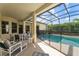 Relaxing screened-in pool area with lounge chairs and tropical landscaping at 305 Grand Reserve Dr, Davenport, FL 33837