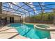 Sparkling screened-in pool with a spa and lush landscaping at 305 Grand Reserve Dr, Davenport, FL 33837