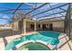 Inviting screened-in pool with a spa and a covered patio area at 305 Grand Reserve Dr, Davenport, FL 33837