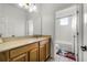 Bright bathroom with a wooden vanity and an adjoined bathroom at 3172 Montserrat Pl, Kissimmee, FL 34743