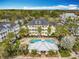 Aerial view showcasing community pool, palm trees, and buildings with balconies at 411 Old Farm Ln, Winter Springs, FL 32708