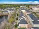 Wide aerial view of the community showcasing its proximity to local shops, pond, and walking trails at 411 Old Farm Ln, Winter Springs, FL 32708