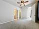 Spacious bedroom with a ceiling fan and multiple doorways including an ensuite and closet at 411 Old Farm Ln, Winter Springs, FL 32708