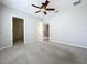 Bedroom featuring carpet, ceiling fan, closet, and ensuite bathroom entries at 411 Old Farm Ln, Winter Springs, FL 32708