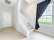 Bright entryway featuring tiled floors, a staircase with white railings, and a window for natural light at 411 Old Farm Ln, Winter Springs, FL 32708