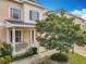 Inviting two-story home with a charming front porch and lush landscaping at 411 Old Farm Ln, Winter Springs, FL 32708