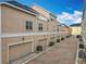 Row of townhomes with brick driveways, attached garages, and well-maintained landscaping at 411 Old Farm Ln, Winter Springs, FL 32708