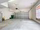 Spacious garage with a closed door, water heater, and room for parking and storage at 411 Old Farm Ln, Winter Springs, FL 32708