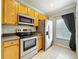 Traditional kitchen design features stainless steel appliances and wood cabinetry at 411 Old Farm Ln, Winter Springs, FL 32708