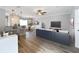 Open-concept living and dining areas with hardwood floors, ceiling fan and breakfast bar seating at 411 Old Farm Ln, Winter Springs, FL 32708