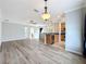 Open-concept living space with hardwood floors, fan, and kitchen access at 411 Old Farm Ln, Winter Springs, FL 32708