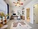 Modern office with a sleek desk, shelves, and decor complemented by an adjacent bathroom at 411 Old Farm Ln, Winter Springs, FL 32708