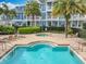 Community pool and spa area surrounded by lounge chairs and tropical landscaping at 411 Old Farm Ln, Winter Springs, FL 32708