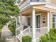 Cozy front porch with white railing and pillars, furnished with comfortable seating for relaxing outdoors at 411 Old Farm Ln, Winter Springs, FL 32708