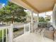 Relaxing front porch with comfortable chairs and a table, offering peaceful views of the street and nearby lake at 411 Old Farm Ln, Winter Springs, FL 32708
