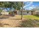 A view of the back of the home showing the deck, fenced yard, and mature landscaping at 416 Davis Dr, Orlando, FL 32803