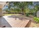 Spacious backyard featuring a wooden deck and mature trees, perfect for outdoor entertaining and relaxing at 416 Davis Dr, Orlando, FL 32803