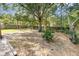 Large backyard with mature trees and a wooden fence providing shade and privacy at 416 Davis Dr, Orlando, FL 32803