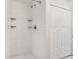 Updated bathroom featuring a tiled shower with built-in shelves and white bi-fold doors at 416 Davis Dr, Orlando, FL 32803