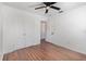 Bedroom with wood laminate flooring, a ceiling fan, and double-door closet for ample storage at 416 Davis Dr, Orlando, FL 32803